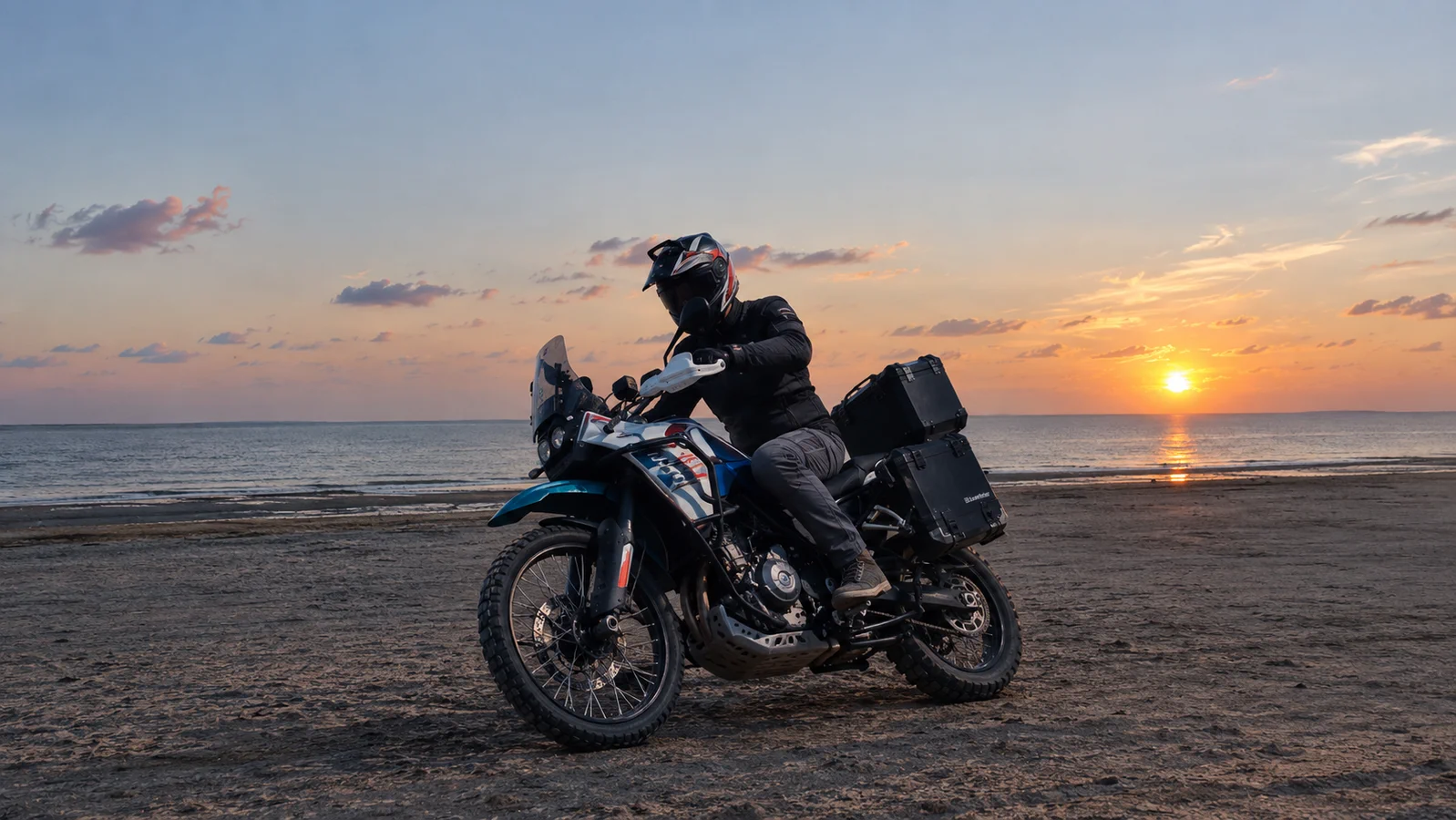 Motorcyclist riding along a beach